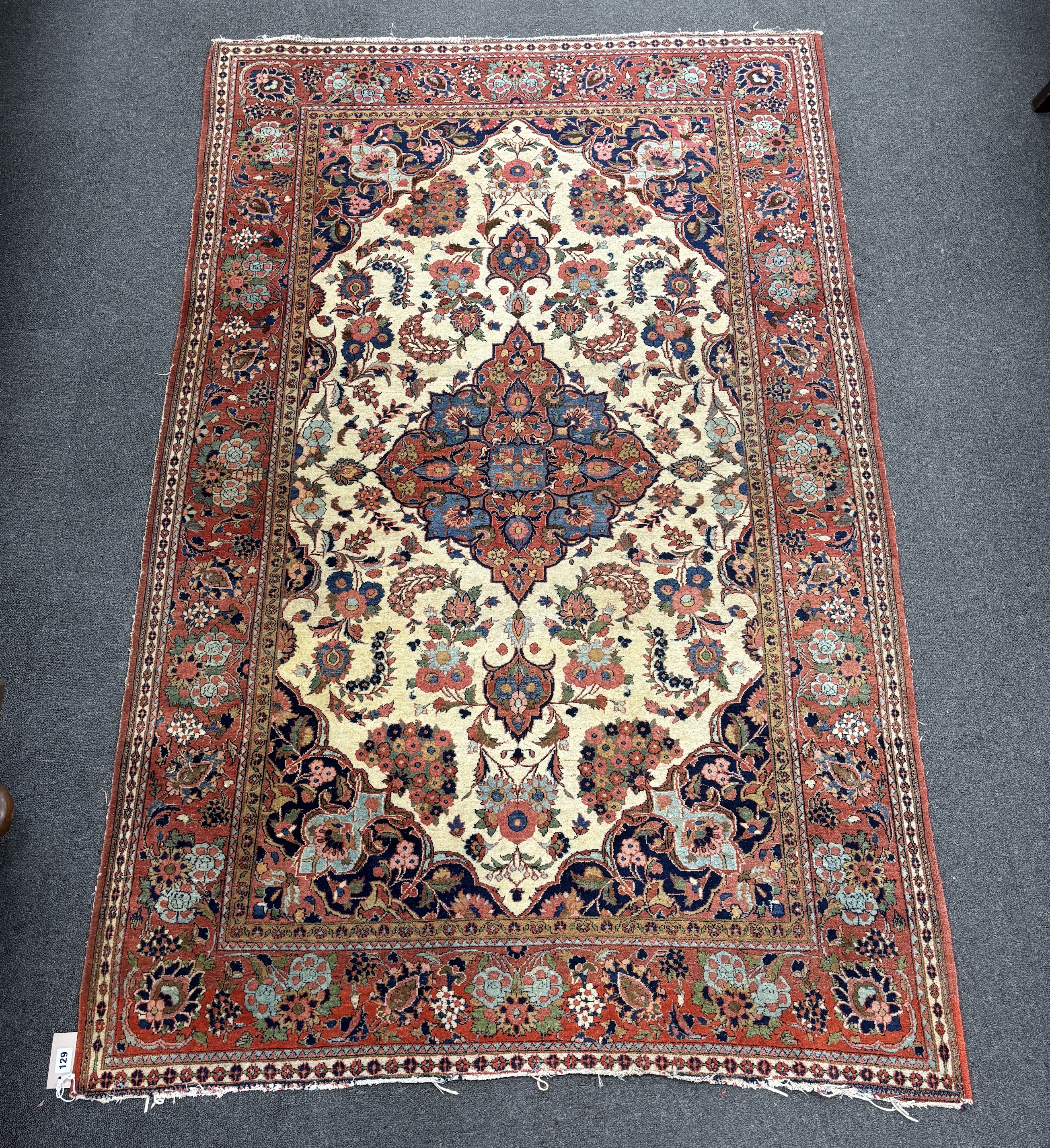 A North West Persian ivory ground rug, 204 x 127cm